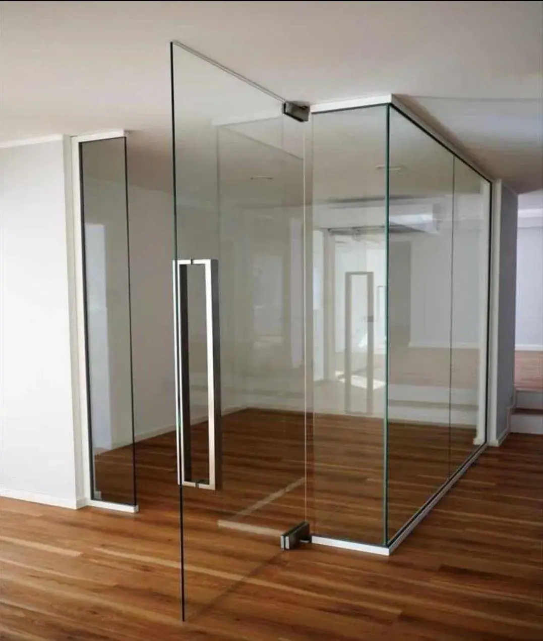 Frameless glass door at a modern office entrance